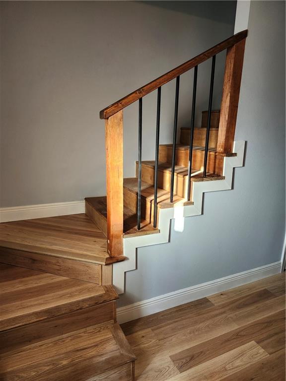 staircase featuring hardwood / wood-style flooring