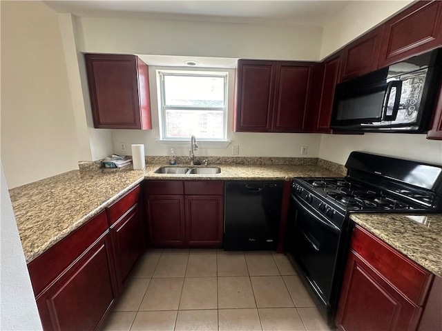 kitchen featuring black appliances, sink, light tile patterned floors, and light stone countertops