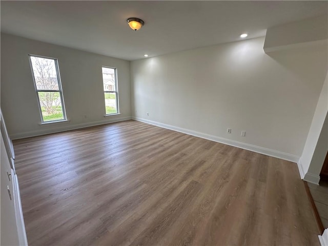 empty room with hardwood / wood-style flooring