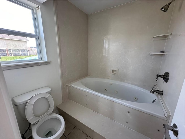 bathroom featuring shower / bath combination, tile patterned flooring, and toilet