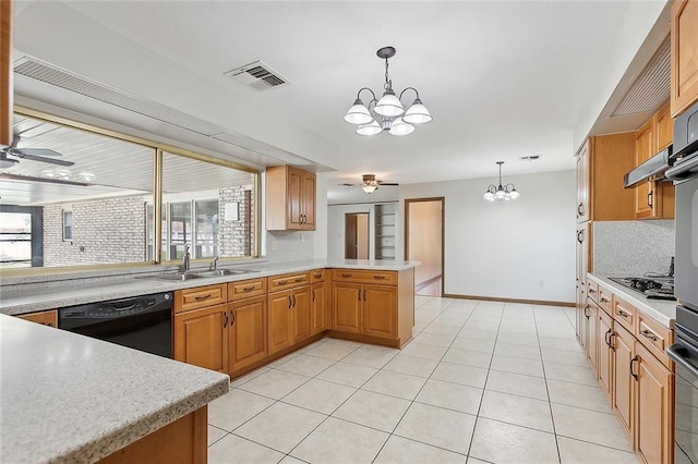 kitchen with kitchen peninsula, pendant lighting, black appliances, sink, and ceiling fan with notable chandelier