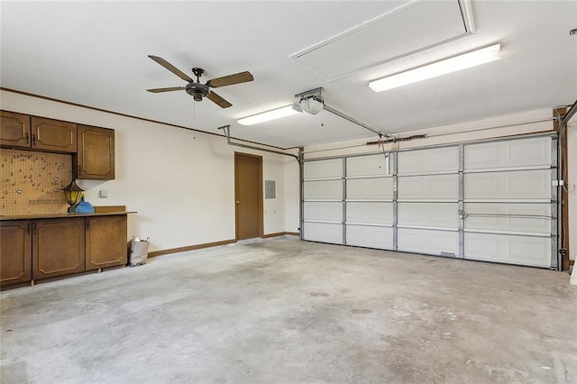 garage with a garage door opener and electric panel