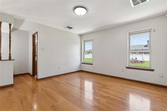 unfurnished room with light hardwood / wood-style floors and a healthy amount of sunlight