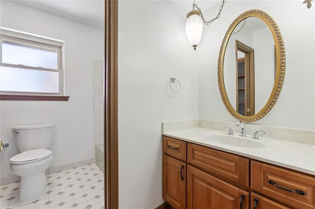 bathroom with vanity, a tub to relax in, and toilet