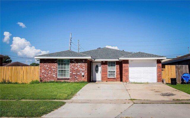 ranch-style home featuring a garage and a front yard