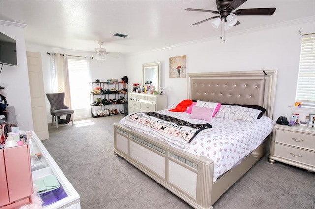 bedroom with crown molding, light colored carpet, multiple windows, and ceiling fan