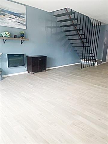 unfurnished living room with hardwood / wood-style flooring