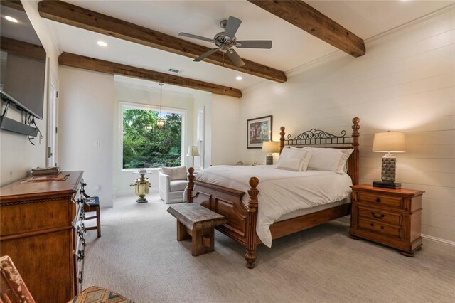 bedroom featuring ceiling fan, light colored carpet, and beamed ceiling