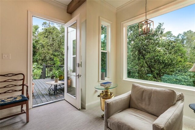 sunroom with a healthy amount of sunlight and a chandelier