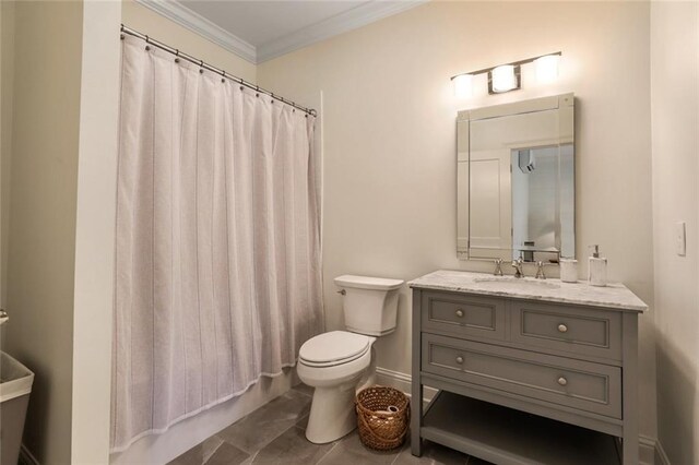 bathroom featuring vanity, crown molding, tile patterned floors, and toilet