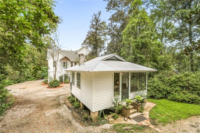 view of outbuilding with a sunroom