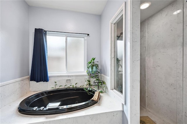 bathroom featuring tiled tub