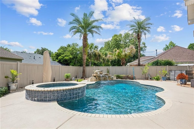 view of pool with pool water feature, a patio area, and an in ground hot tub