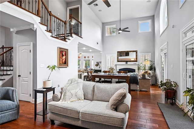 living room with ceiling fan, high vaulted ceiling, and dark hardwood / wood-style flooring