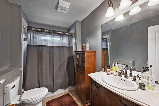 bathroom with walk in shower, toilet, vanity, and a textured ceiling