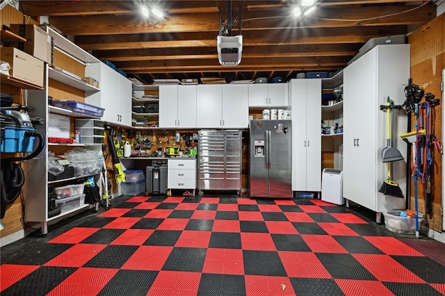 basement with stainless steel fridge with ice dispenser