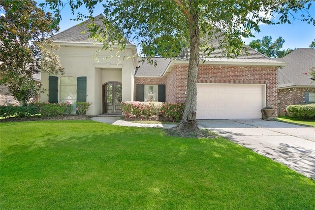 view of front of property with a garage and a front yard