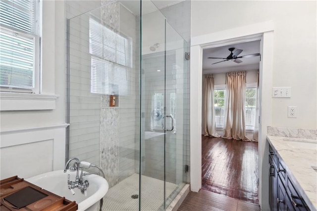 bathroom with independent shower and bath, vanity, hardwood / wood-style flooring, and ceiling fan