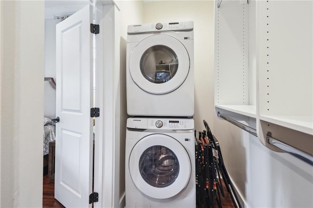 1720 Lapeyrouse St, New Orleans, LA 70116 - clothes washing area featuring stacked washer / dryer and wood finished floors