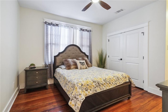 bedroom with dark wood-type flooring, a closet, and ceiling fan