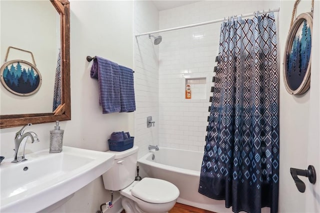 full bathroom with shower / tub combo with curtain, sink, and toilet