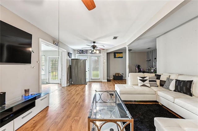 living room featuring light wood-type flooring and ceiling fan