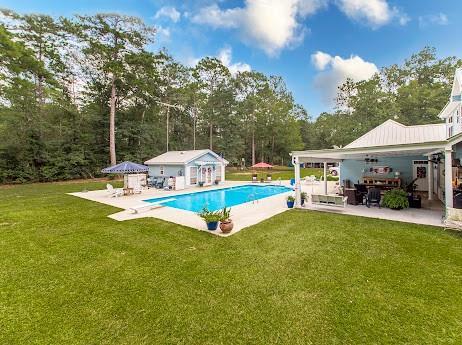 view of swimming pool featuring a patio area and a yard