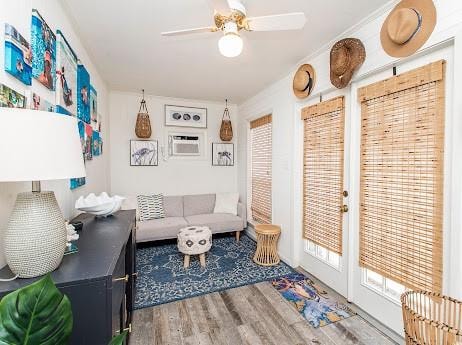 living room with hardwood / wood-style flooring and ceiling fan