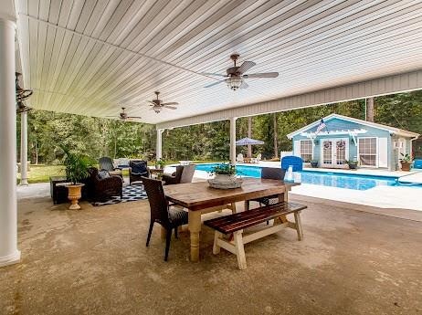 view of patio featuring ceiling fan and an outdoor structure