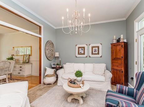 living room featuring a notable chandelier and crown molding