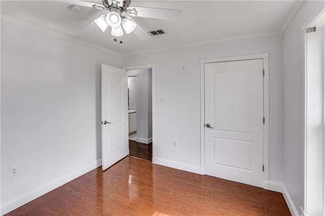 1112 Michael St, Marrero, LA 70072 - unfurnished bedroom featuring dark wood-type flooring, ceiling fan, and crown molding