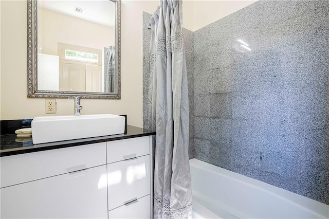 bathroom featuring vanity, shower / tub combo, and visible vents