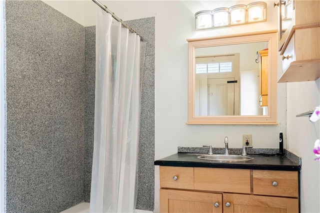 bathroom featuring vanity and a shower with shower curtain