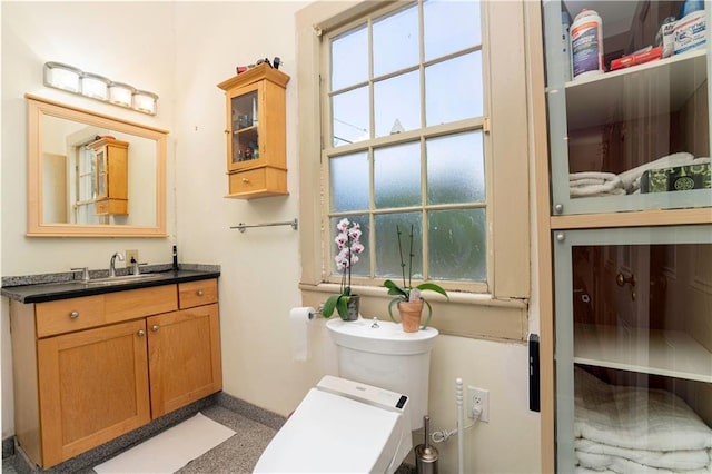 bathroom featuring vanity and toilet