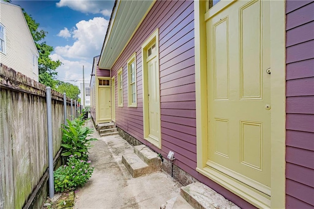 view of home's exterior with fence and entry steps