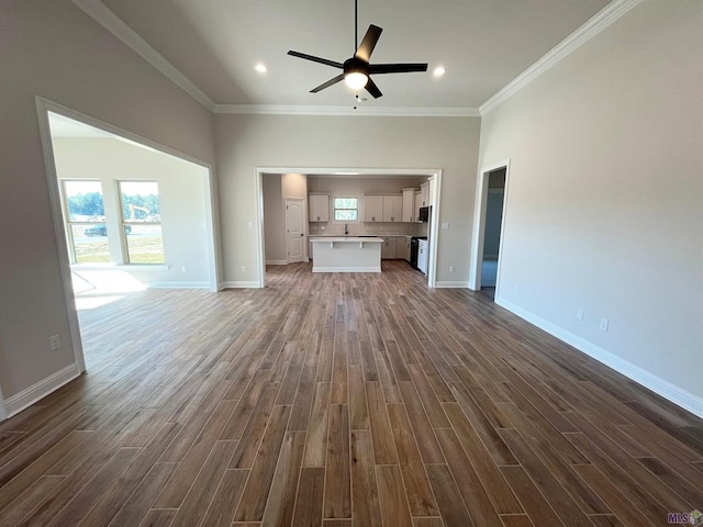 unfurnished living room with ornamental molding, sink, ceiling fan, and dark hardwood / wood-style flooring