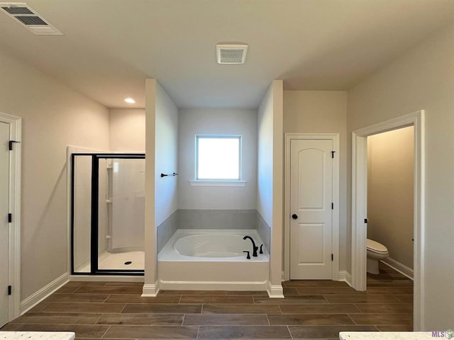 bathroom with toilet, wood-type flooring, and independent shower and bath