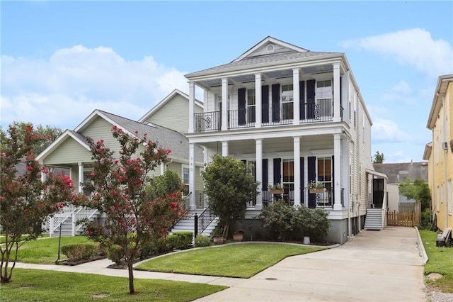 view of front of house with a balcony, a porch, and a front yard