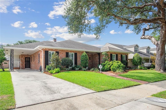 ranch-style home featuring a front yard and a carport