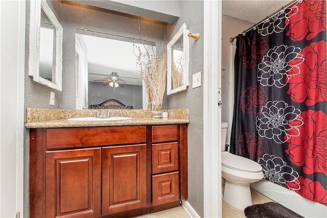 bathroom with tile patterned floors, vanity, ceiling fan, and toilet