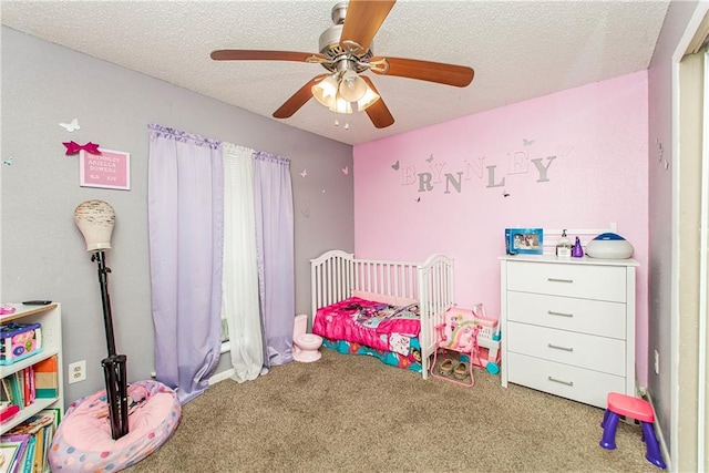 bedroom featuring carpet floors, a textured ceiling, and ceiling fan