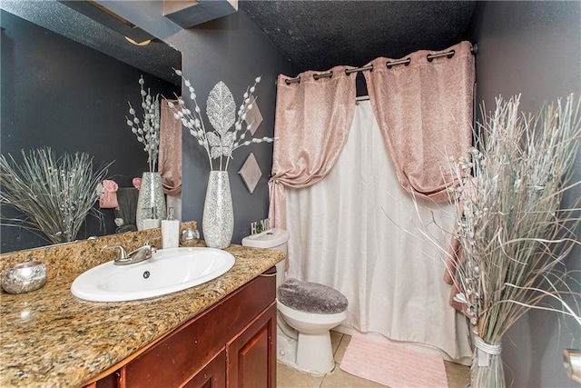 bathroom featuring tile patterned floors, toilet, and vanity