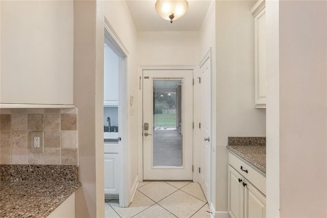 doorway featuring light tile patterned floors