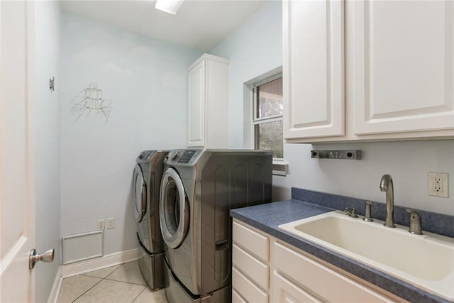 laundry room featuring sink, cabinets, washing machine and clothes dryer, and light tile patterned flooring