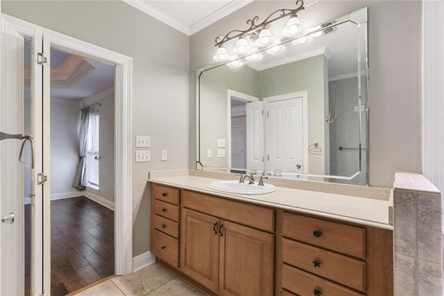 bathroom featuring tile patterned floors, ornamental molding, and vanity