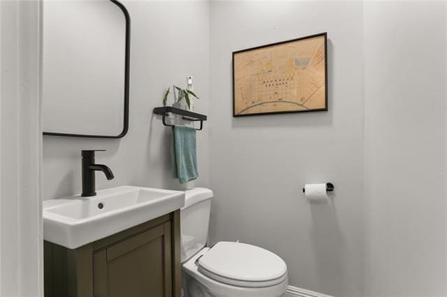 bathroom with toilet and vanity