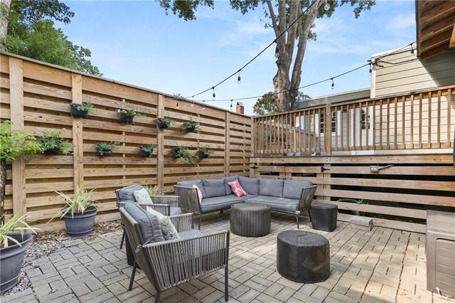 view of patio featuring an outdoor living space and a wooden deck