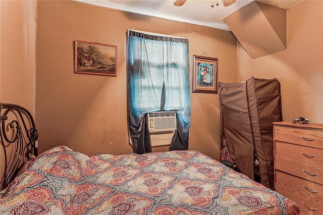 bedroom featuring a textured ceiling, ceiling fan, and cooling unit