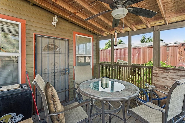 exterior space featuring outdoor dining area, fence, and a ceiling fan