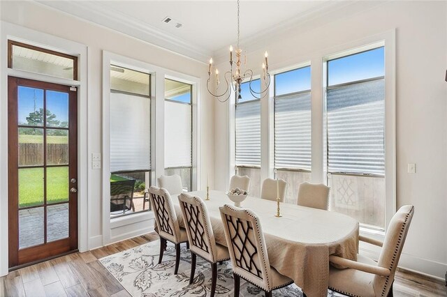 285 Cypress Lakes Dr, Slidell, LA 70458 - dining space with crown molding, light wood-type flooring, baseboards, a chandelier, and visible vents